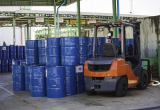 Oil barrels forklift truck move for on the transportation truck.