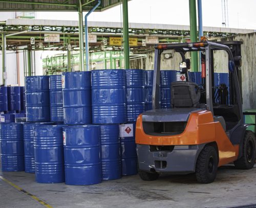 Oil barrels forklift truck move for on the transportation truck.