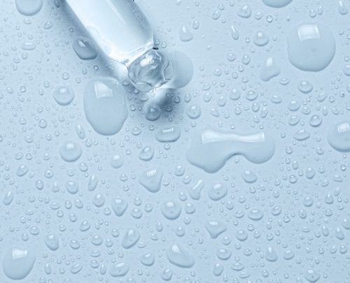 Micellar water drops and pipette. Cosmetic product for moisturizing the skin or removing makeup. Closeup, macro photography.